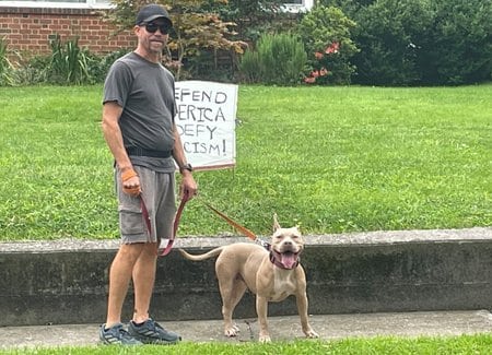 Certified dog trainer Daniel Pruden with a pit bull.